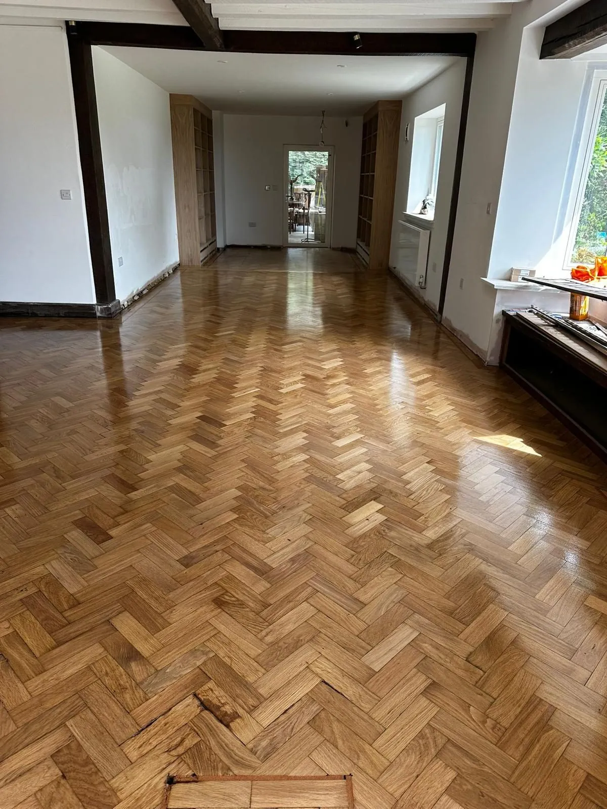 Oak parquet floor repaired with replacement blocks in a beamed reception room | Northfold Flooring