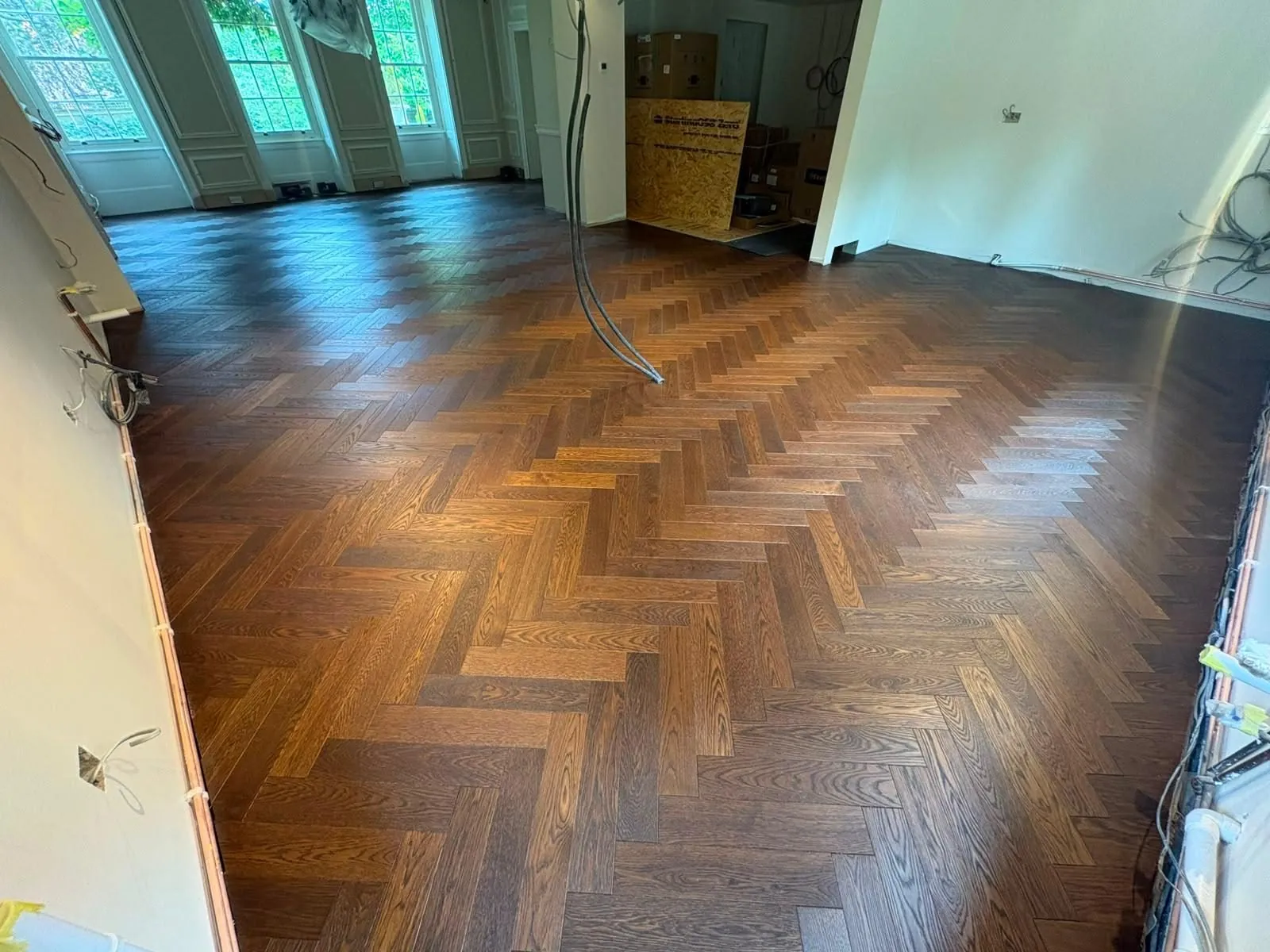 Newly installed dark herringbone oak floor in an open-plan room | Northfold Flooring