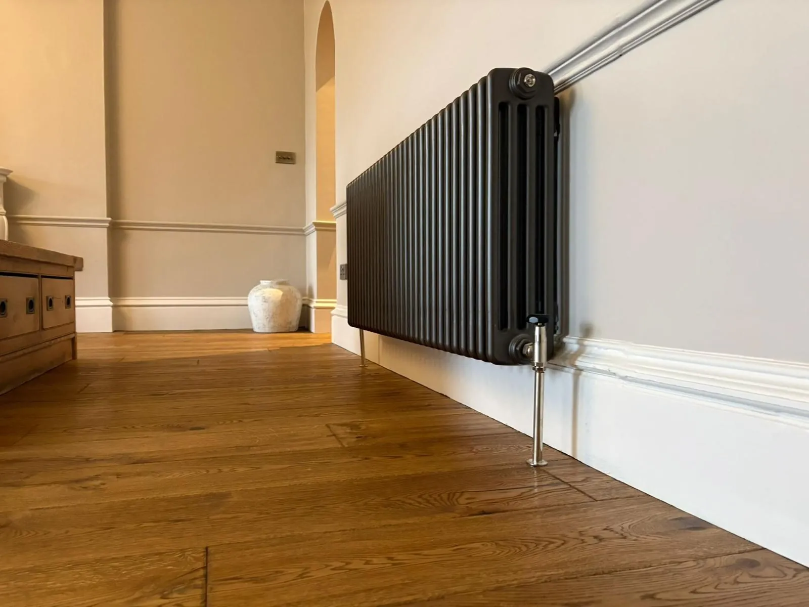 Character oak plank flooring fitted neatly around a column radiator | Northfold Flooring