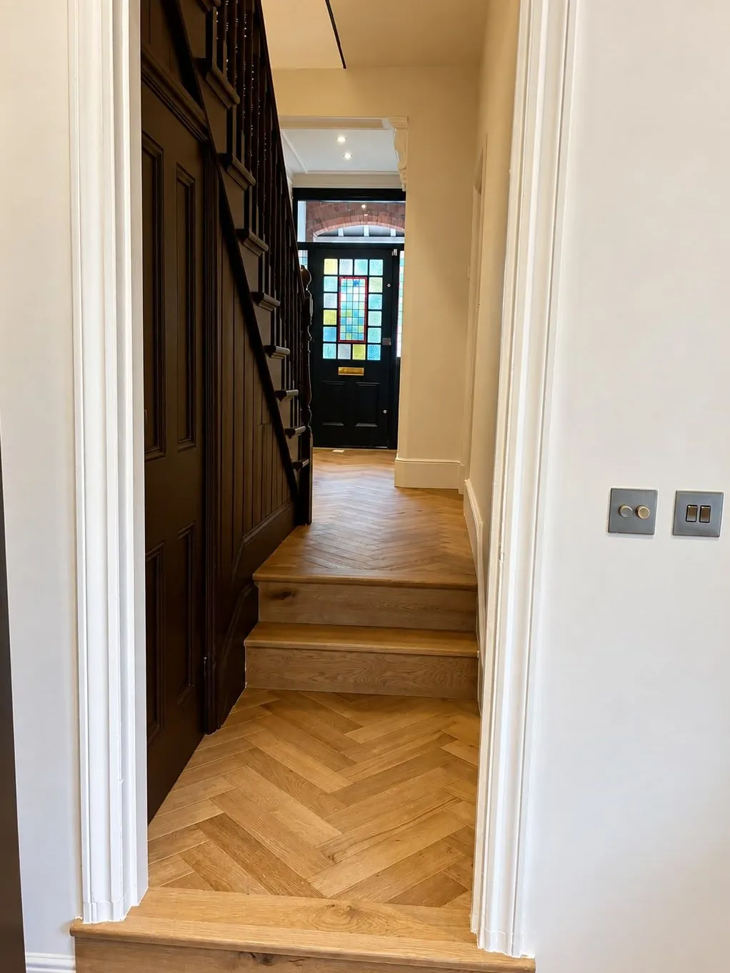 Herringbone oak flooring installed in a Victorian hallway