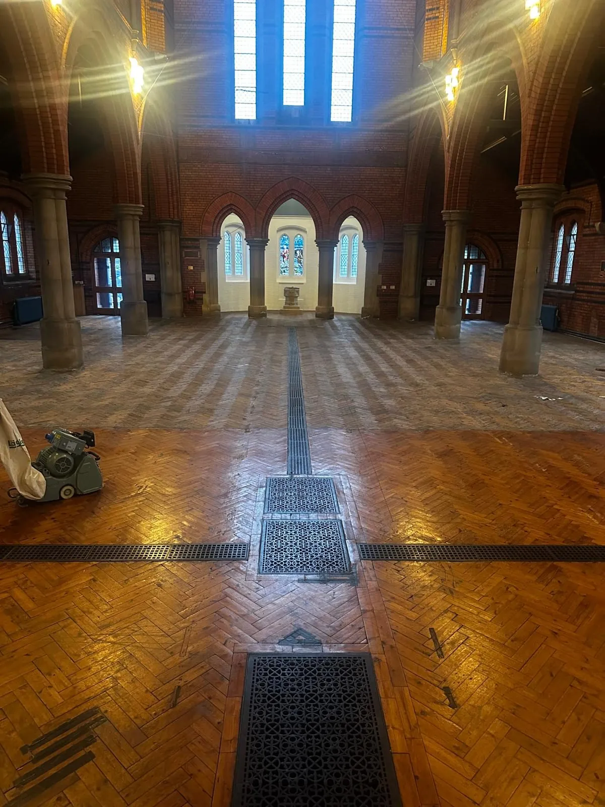 Church parquet floor part-way through sanding and refinishing, showing worn and sanded sections | Northfold Flooring