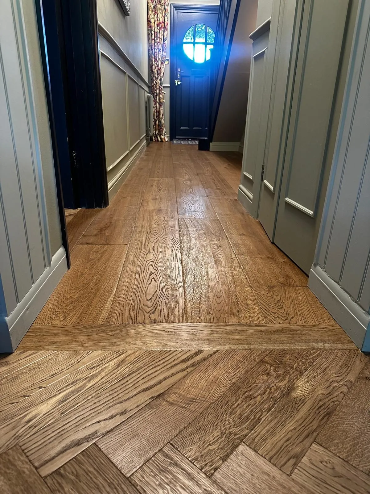Oak plank hallway meeting herringbone oak at a threshold | Northfold Flooring
