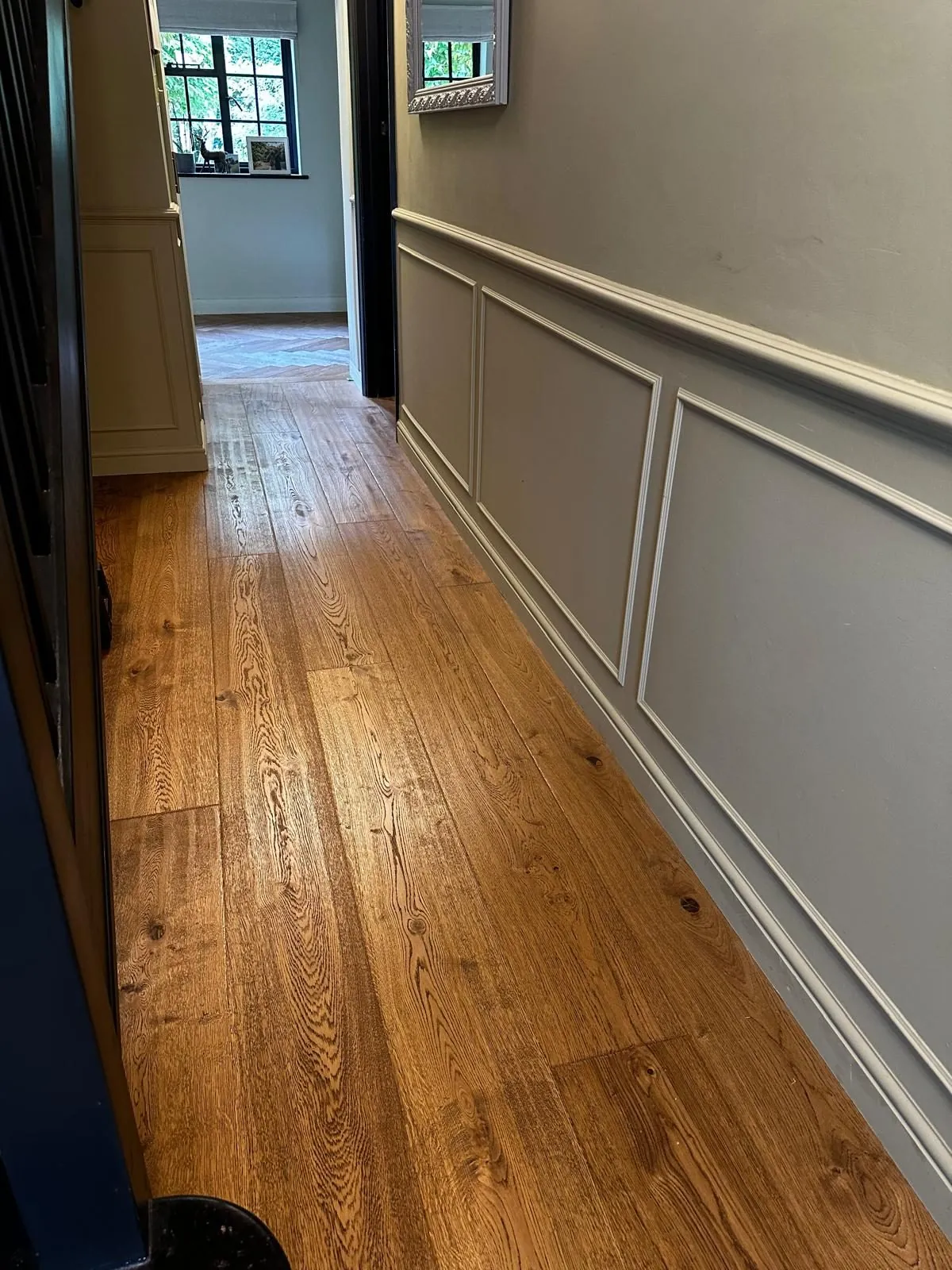 Character oak plank hallway floor beside panelled walls | Northfold Flooring