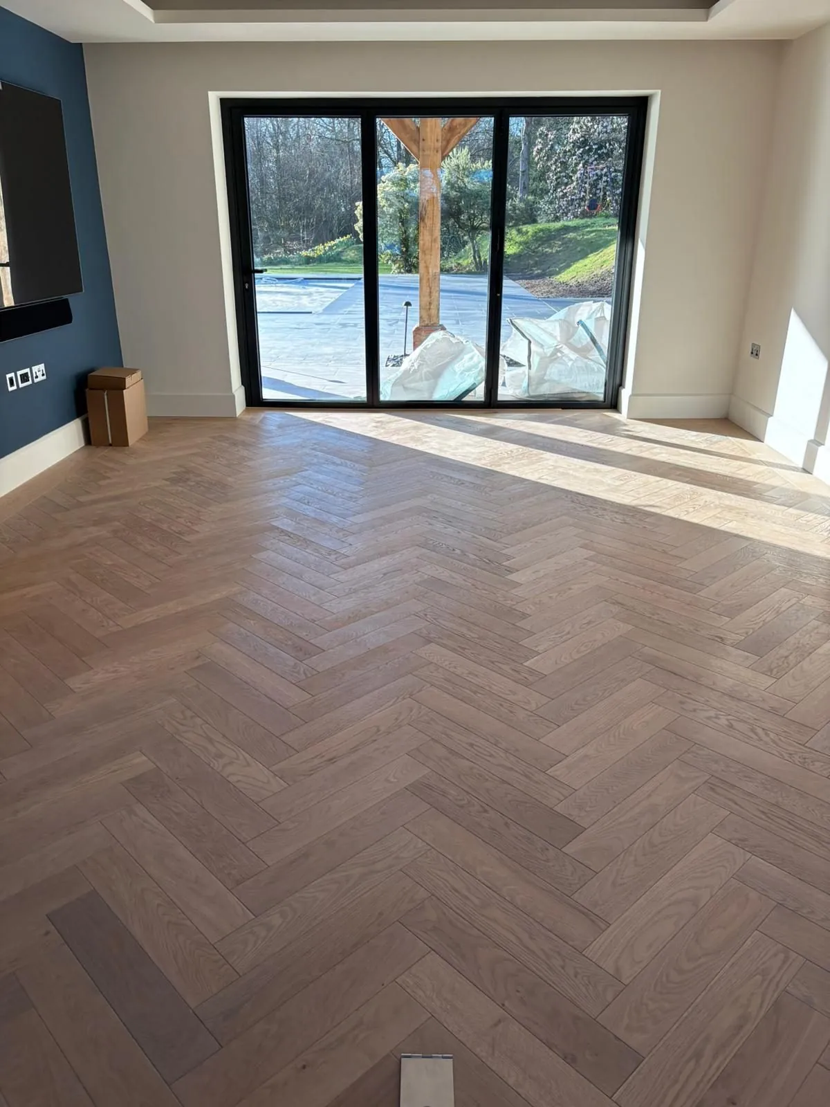 Herringbone oak floor in a garden room with sliding doors | Northfold Flooring