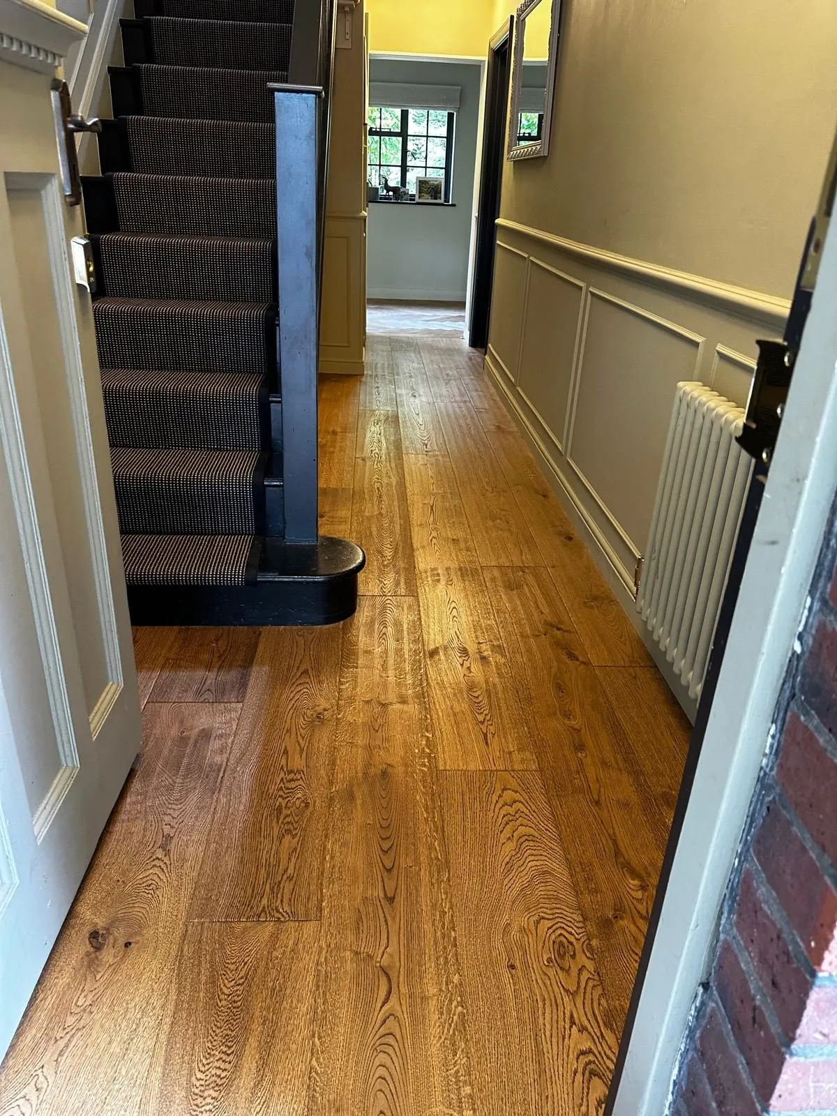 Character oak plank flooring fitted along a hallway to the stairs | Northfold Flooring
