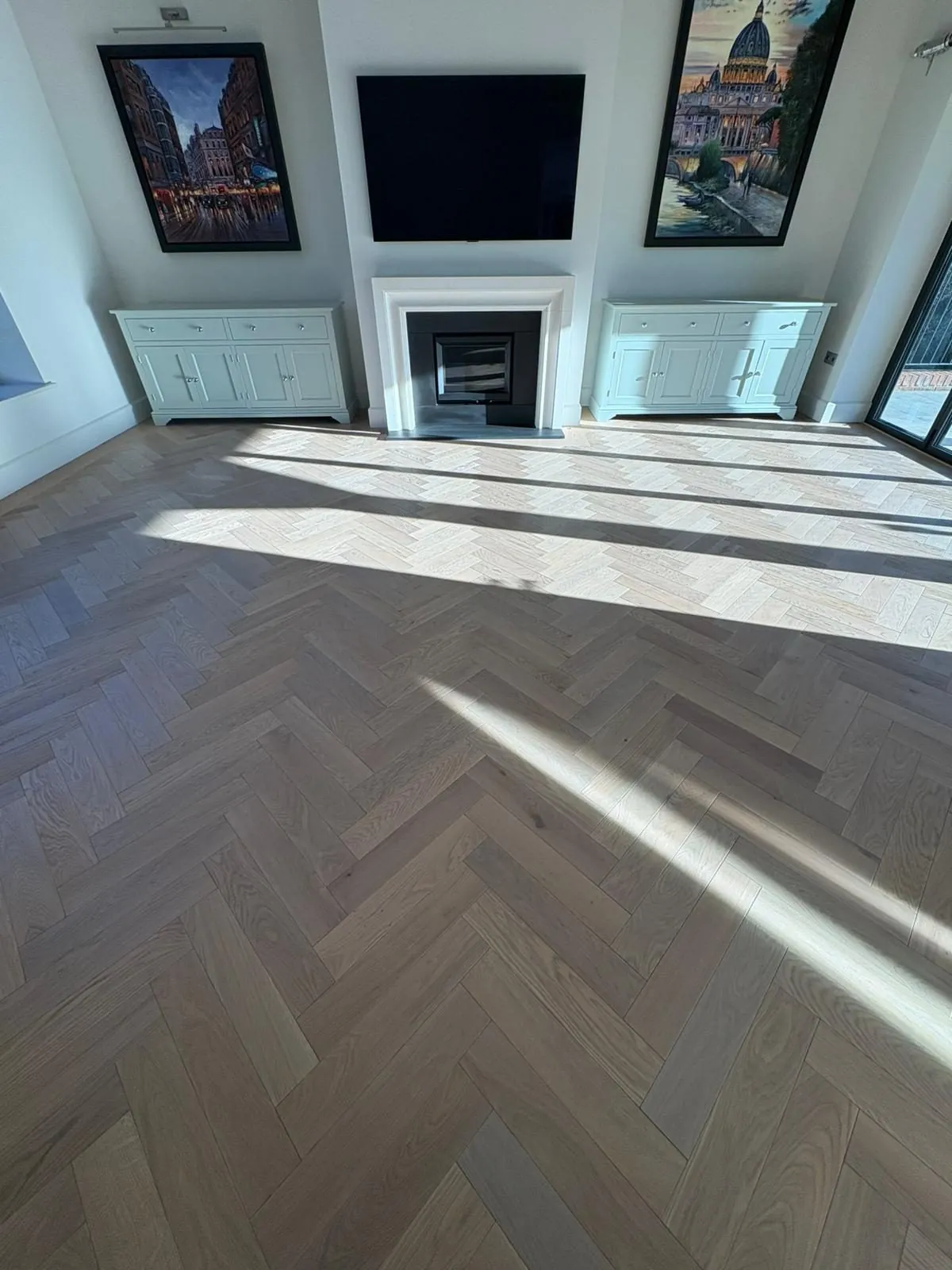 Sunlight across a herringbone oak living room floor | Northfold Flooring