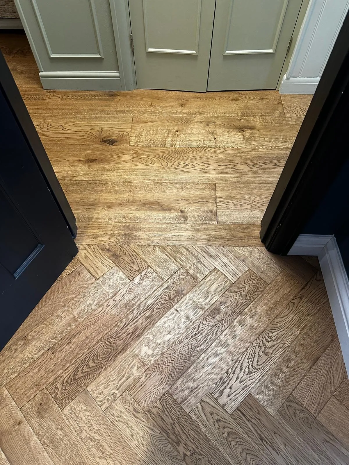 Close-up of an oak plank to herringbone threshold detail | Northfold Flooring